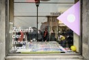 Aerial photo with flags in the shop window of the Agency for Urban Change © Moritz Bernoully 